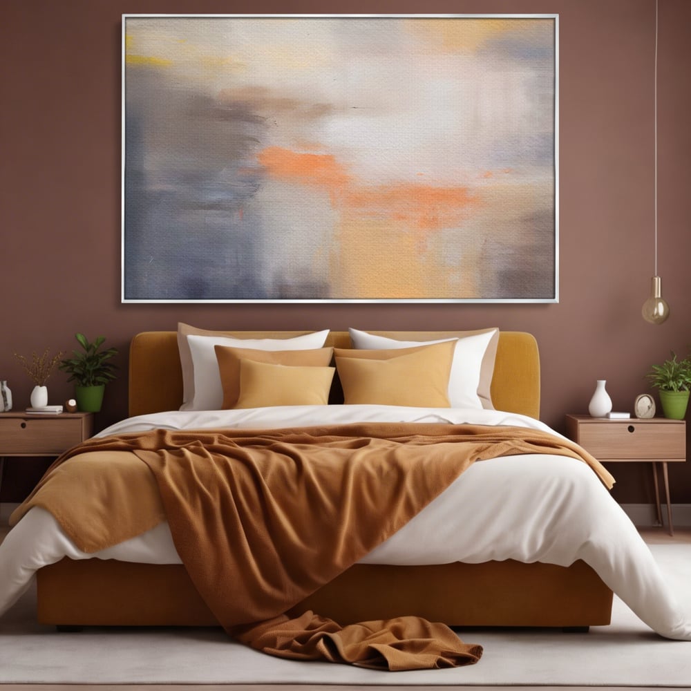 Tablou canvas cu pictura abstracta cu pete portocalii, in rama de aluminiu argintiu, pe perete intr-un dormitor